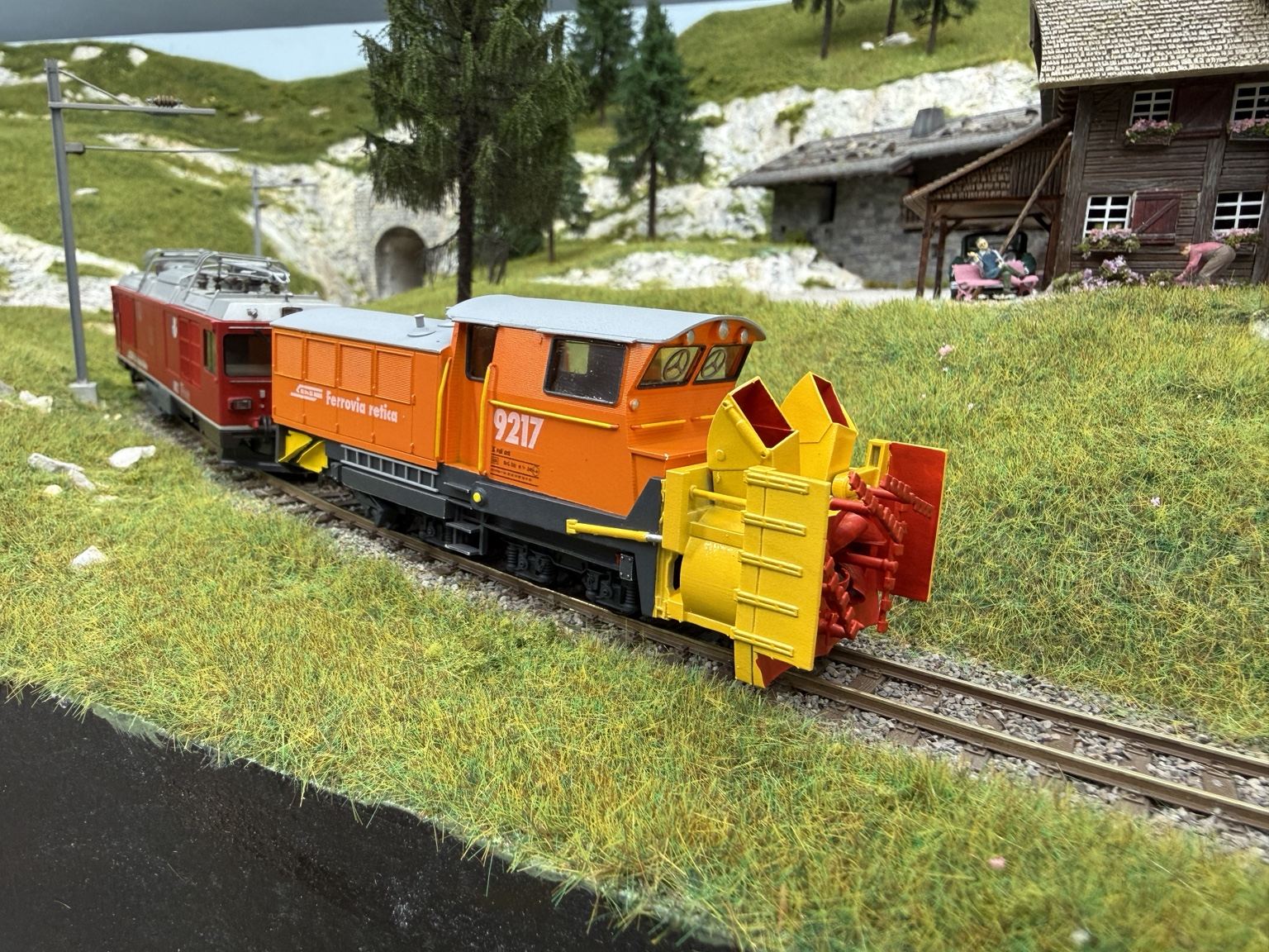3D-printed RhB Xrot 9217 rotary snowplough on an Alpine railway layout